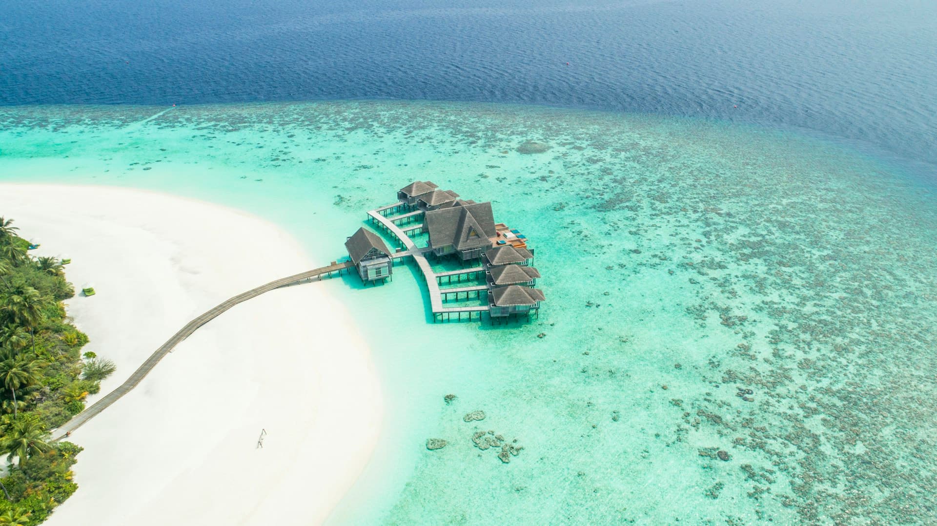 Overwater bungalows in crystal clear Maldives ocean